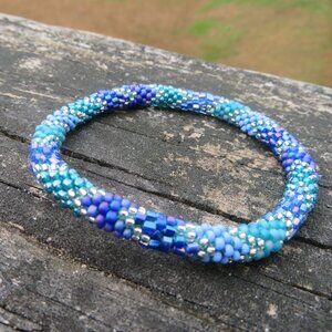 NWOT Nepal Roll On Bracelet Crochet Agave Blue Purple Clear